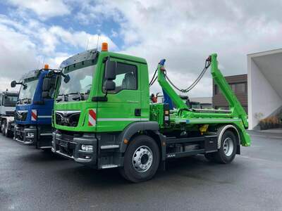 A pair of skip loader, blue and green